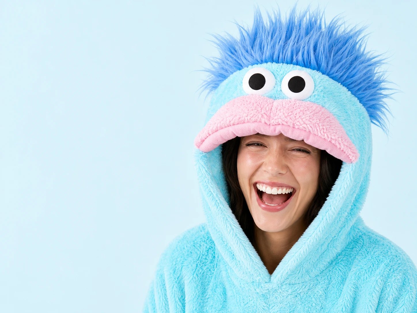 Close-up of the monster hood with googly eyes, pink lips and fluffy hair
